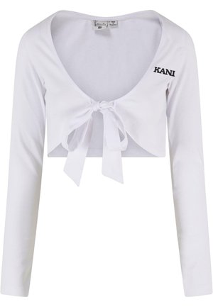 Top blanco corto de manga larga con escote profundo, cierre delantero con lazo y logo bordado "KANI" en el lado izquierdo. Hecho de una tela suave.