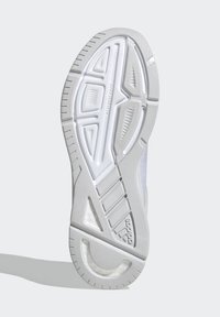 White athletic shoe sole with textured rubber, featuring a distinctive tread pattern and marked accents. Logo visible on the side.