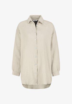 Light beige button-up shirt with a textured, wrinkled fabric. Features a collar, long sleeves with buttoned cuffs, and a curved hem.