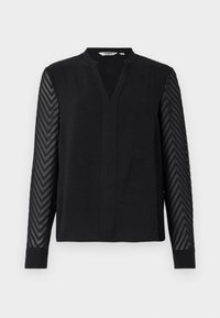 Musta pitkähihaine paita, jossa on V-pääntie ja läpikuultavat zigzag-kuvioiset hihat, istuvat hihansuut ja rento, suora helma.