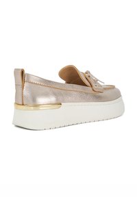 Metallic gold slip-on shoes with a leather upper, tan accents, and textured finish. Features a thick white sole with a gold trim.