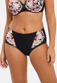 Culotte alta nera con texture a costine, caratterizzata da ricami floreali rosa e bianchi sui lati e un piccolo dettaglio con fiocchetto decorativo.