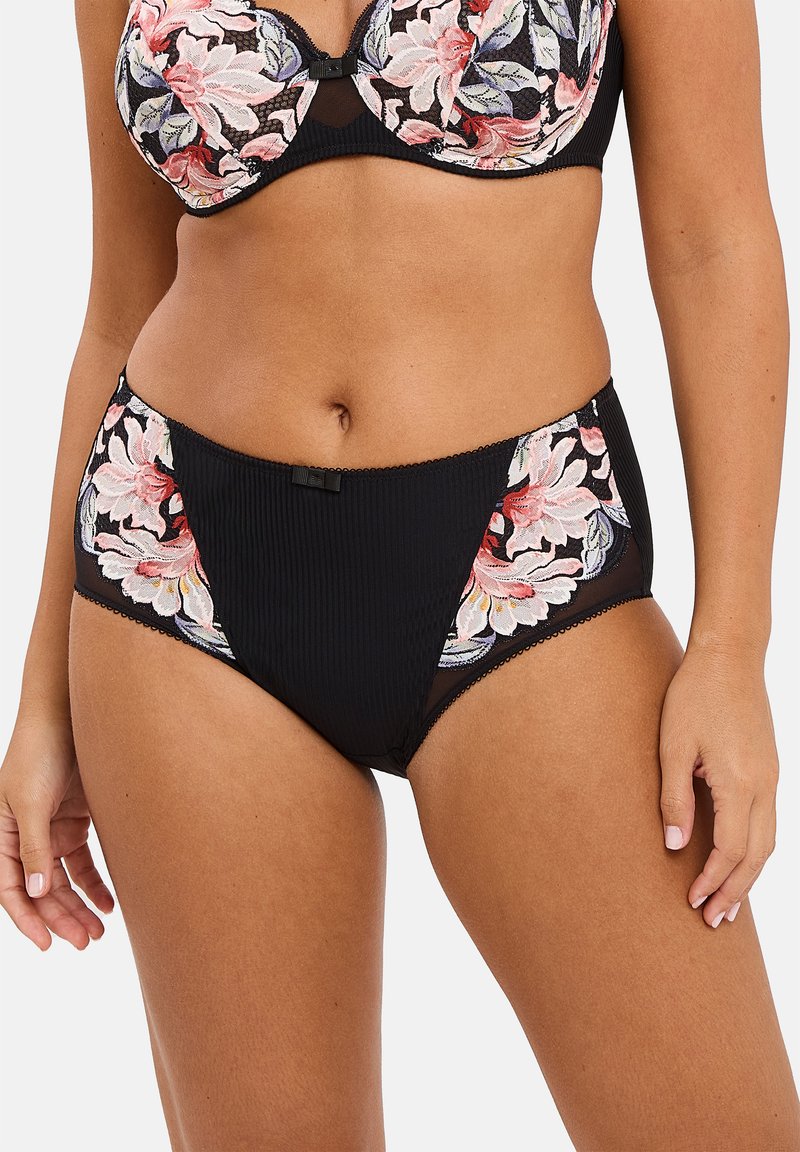 Culotte alta nera con texture a costine, caratterizzata da ricami floreali rosa e bianchi sui lati e un piccolo dettaglio con fiocchetto decorativo.