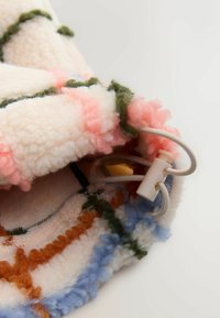 Fuzzy, pastel fleece fabric featuring pink, light blue, green, and orange patterns with a white drawstring and plastic toggle.