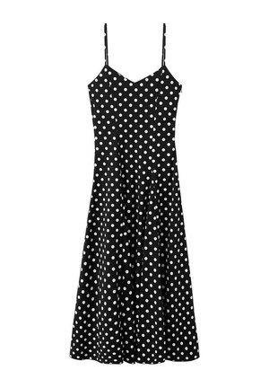 Robe midi noire à pois blancs, bretelles spaghetti et corsage ajusté s'évasant en jupe trapèze.