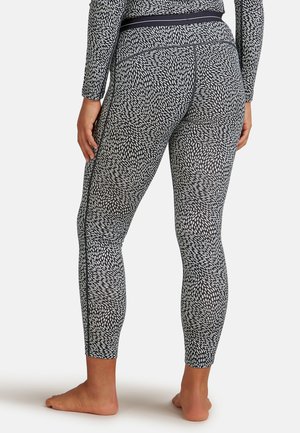 Schwarz hoch geschnittene Leggings mit einem weißen abstrakten Muster, die über eine glatte Textur und ein enges Design verfügen, das die Beine umschmeichelt.