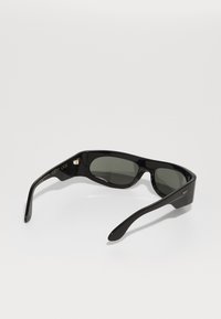Black sunglasses with dark gray lenses. Plastic frame with a sleek design. Arms feature the initials "RSF" in gold on one side.