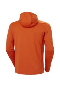 Kapurowa koszulka z długim rękawem w jasnym pomarańczowym kolorze, wyróżniająca się gładką fakturą, bocznymi szwami oraz kontrastowymi detalami zszycia.