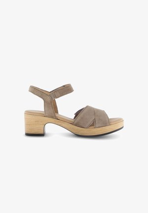 Brown suede open-toe sandal with adjustable ankle strap, low wooden block heel, and cushioned footbed on a white background.
