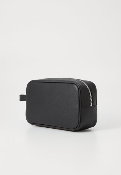 Black rectangular toiletry bag made of textured synthetic material, featuring a double zipper closure and a side handle for easy carrying.
