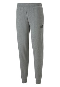 Pantalon en molleton gris avec taille élastique, poches latérales, jambes fuselées et logo noir en caoutchouc sur le côté gauche. Texture douce.
