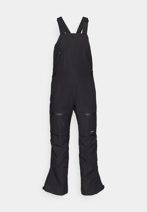 Schwarze Schneeoverall mit verstellbaren Trägern, Fronttasche und zwei seitlichen Reißverschlusstaschen. Hergestellt aus strapazierfähigem, wasserabweisendem Stoff.