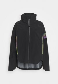 Veste noire à capuche avec fermeture éclair à l'avant, manches longues et logo Adidas irisé sur le haut du bras gauche.
