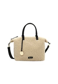 Cream-colored shearling handbag with black leather handles and detachable strap, featuring a round gold tag and rectangular logo patch.