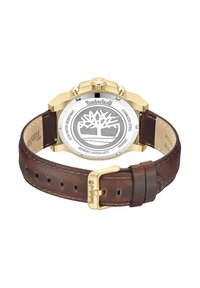 Orologio con cinturino in pelle marrone e cassa in acciaio inossidabile color oro, caratterizzato da un fondo circolare argentato con un logo ad albero e dettagli di resistenza all'acqua.