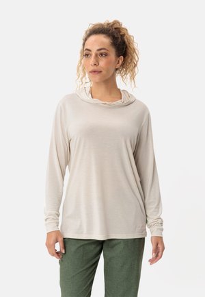 Maglietta a maniche lunghe beige chiaro con scollo drappeggiato e vestibilità comoda. Tessuto morbido e liscio, abbinata a pantaloni verde testurizzati.