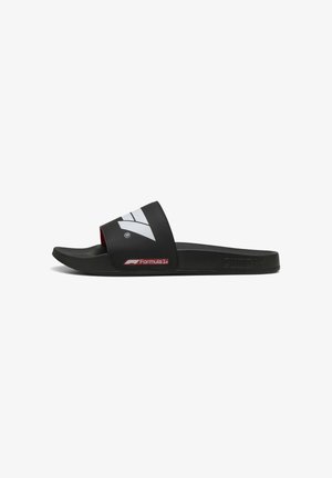 Black slide sandal with a wide strap, featuring white and red accents, Formula 1 logo, and Puma branding. Smooth rubber material, curved sole.