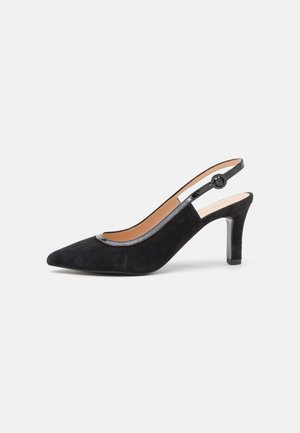 Pompe à talon slingback en suède noir avec un bout pointu, des bords brillants noirs et un talon étroit. Présente un détail en forme de bouton rond sur la sangle.