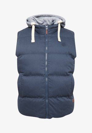 Tamsiai mėlyna pūkinė liemenė su pilkos spalvos kapišonu, priekyje užtrauktuku, dviem šoniniais kišenėmis ir kreminės spalvos raišteliais. Tekstūrinė medžiaga su pūkų motyvu.