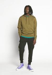 Urban Classics TACTICAL PANTS - Reisitaskuhousut - black