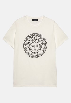 Short-sleeve, cream cotton t-shirt featuring a black Medusa graphic and a circular Greek key border on the front. Classic crew neck design.