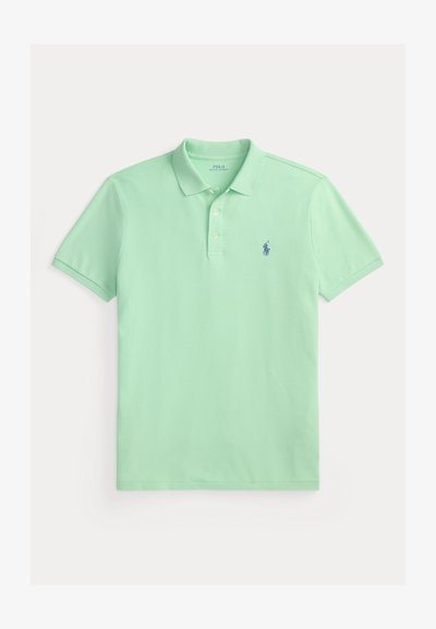 Hellgrünes Polohemd aus glattem Baumwollstoff, mit einer Knopfleiste mit zwei Knöpfen und einem kleinen blauen, auf der Brust gestickten Logo.