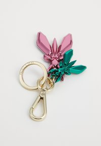 Portachiavi con tre cristalli in rosa e verde, dotato di anello e chiusura dorati. I cristalli sono sfaccettati, mostrando colori e forme vivaci.