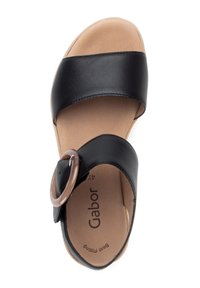 Black sandal featuring two wide straps, one with a circular brown accent. Smooth leather texture with a cushioned insole. Gabor branding visible.