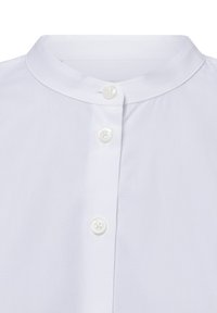 White shirt featuring a band collar and three front buttons. Made of smooth fabric with a subtle texture and no visible patterns.