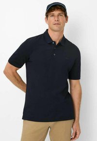 Navy polo shirt made of smooth cotton, featuring a classic collar, three-button placket, and a small logo detail on the chest.