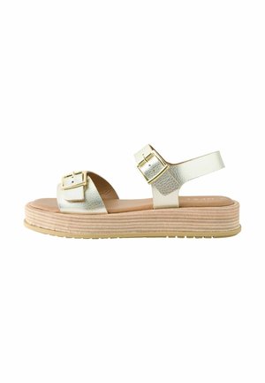 Sandalo con plateau dallo strato metallico testurizzato, dotato di doppia fibbia e suola strati beige. Presenta una cinghia alla caviglia regolabile e una soletta liscia.