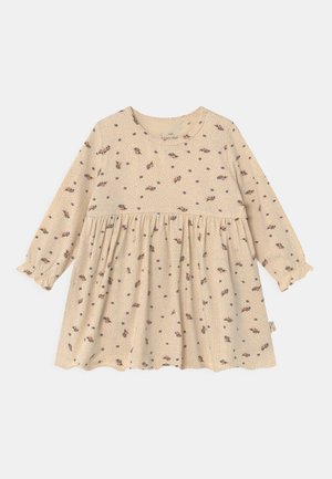 Jasnobeżowa sukienka z długimi rękawami, okrągłym dekoltem i marszczoną talią. Charakteryzuje się kwiatowym wzorem i kropkami, z falbaniastymi mankietami.