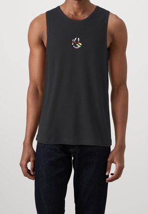 Black sleeveless tank top with a ribbed texture and a multicolored logo on the chest. Simple round neck design, paired with dark denim jeans.