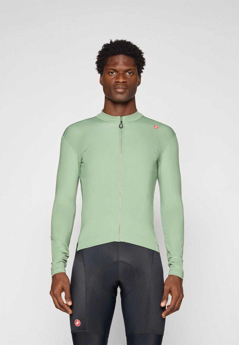 Long-sleeve cycling jersey in light green, featuring a front zipper and slim fit. Paired with black cycling shorts, highlighting athletic design.