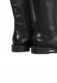 Black leather knee-high boots with a smooth finish, side zippers, and a low stacked heel. The design features stitched accents near the ankle.