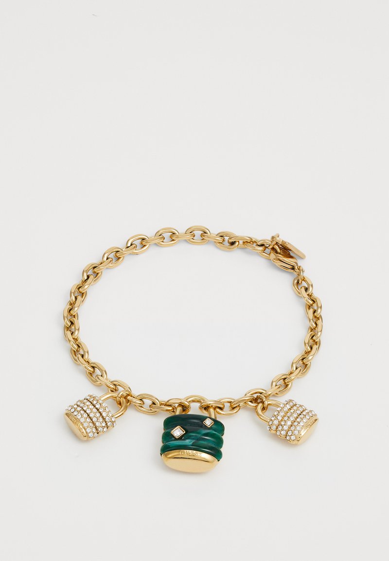 Gold chain bracelet featuring three charms: one green textured, one adorned with clear crystals, and a smaller gold accented charm.