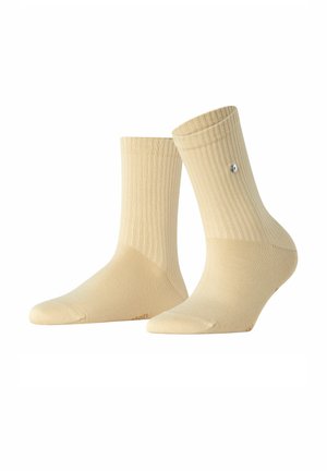 Beige katoenen crew sokken met een geribbelde textuur en een omgeslagen bovenrand, met een klein logo aan de zijkant.