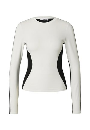 Langsleeve top in het wit met zwarte zijkanten, ronde hals, getailleerd ontwerp en een gladde textuur. Geen patronen of hardware zichtbaar.
