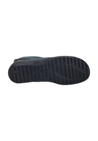 Black rubber boot sole with deep tread patterns; features a flat, textured surface for grip and stability.