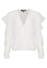 Blouse blanche avec un col en V, des manches bouffantes douces, un motif à pois texturé et des boutons sur le devant.