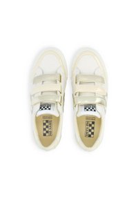 White sneakers with two golden Velcro straps, smooth leather upper, rounded toe, cushioned insole, and a black-and-white checkered logo on the tongue.