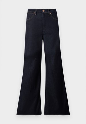 Dunkel indigoblaue High-Waist Jeans mit weitem ausgestelltem Bein, vorderem Knopf, Reißverschluss und zwei vorderen Taschen mit Kupfernieten.
