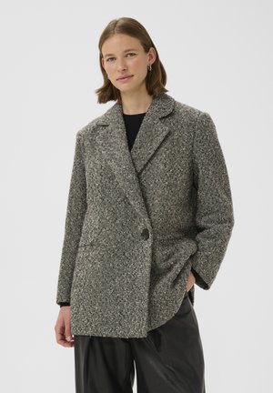 Wollen blend jas in een zwart-wit houndstooth patroon, met een ingesneden kraag, dubbele knoopsluiting en voorzakken.