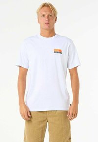 White cotton t-shirt featuring a small colorful "RIPCURL" logo on the left chest. Classic crew neck design.