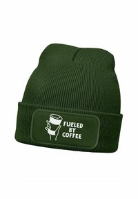Dark green knit beanie with a folded cuff and a rectangular patch featuring the text "FUELED BY COFFEE" alongside a coffee cup graphic.