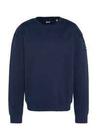 Navyblauwe sweatshirt gemaakt van zacht katoenmixmateriaal. Heeft een ronde halslijn, lange mouwen, geribde manchetten en een minimalistisch ontwerp.