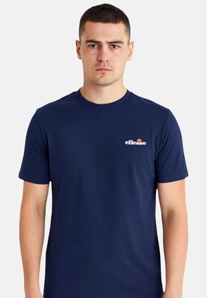 T-shirt à manches courtes bleu marine en tissu lisse. Présente un petit logo blanc sur la poitrine et un col rond classique.