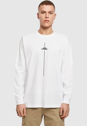 White long-sleeve t-shirt made of cotton, featuring black text "THINK DIFFERENT." in the center. Smooth texture, crew neck design.
