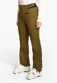 Olivgrüne Skihosen mit hohem Bund, vorderen Reißverschlusstaschen und eng anliegenden Bündchen; aus wetterfestem Material gefertigt. Eignen sich zum Skifahren.