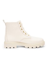 Cream-colored leather combat boot with thick lug sole, seven gold eyelets, and pull tab at the back, shown in side profile.
